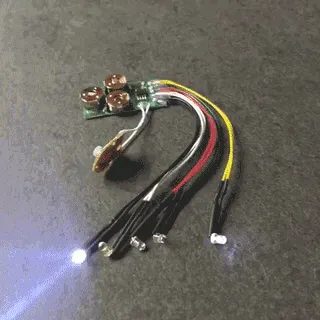 Produktbild von Dieser Artikel enthält eine LED-Leuchte für Zuckertüten, bestehend aus einem Lichtmodul mit 5 separaten weißen LEDs (dauerhaft oder blinkend) und einer elektronischen Platine mit Taster.